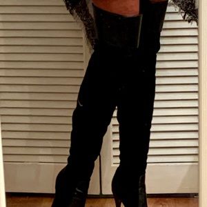 High heeled thigh-high leather black boots.